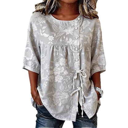 Flor | Blusa con bordado floral en relieve y lazada lateral