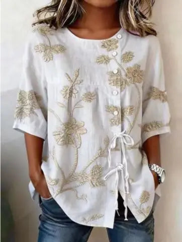 Flor | Blusa con bordado floral en relieve y lazada lateral