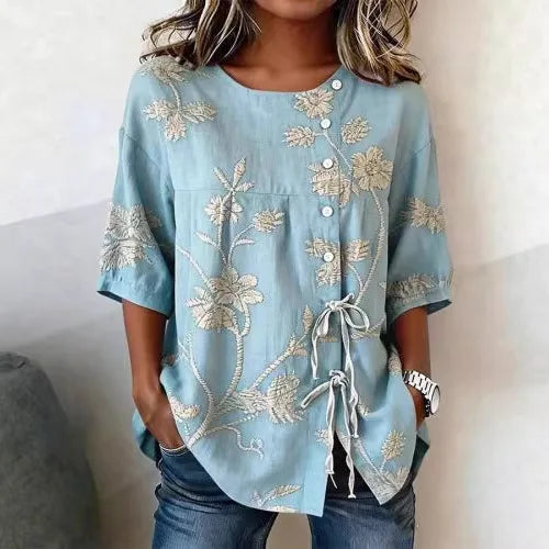 Flor | Blusa con bordado floral en relieve y lazada lateral