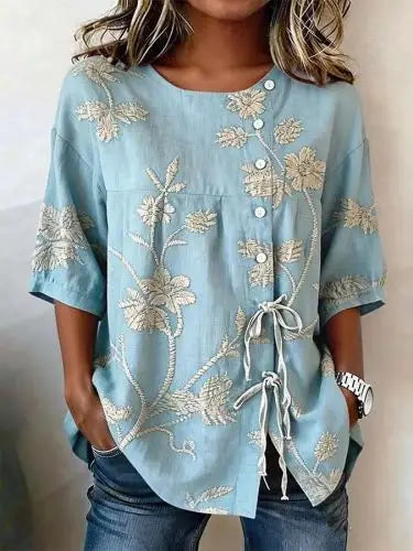 Flor | Blusa con bordado floral en relieve y lazada lateral